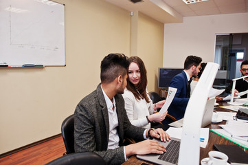 Wall Mural - Multiracial young creative people in modern office. Group of young business people are working together with laptop, tablet. Successful freelancers team in coworking.