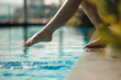 © Kate - Closeup young female leg make splash of blue water in swimming pool