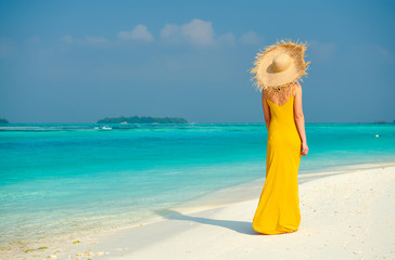 Poster - Woman in dress walking on tropical beach