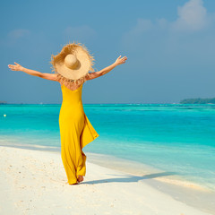 Poster - Woman in dress walking on tropical beach