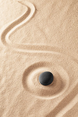 Poster - Raked sand and spa wellness healing stone. Zen buddhism meditation stone for concentration and relaxation through minimalism and purity. Spiritual background with copy space.