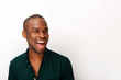 © mimagephotos - Close up happy young african american guy laughing against isolated white background