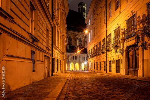 Austria Vienna Metastasiogasse Narrow Alleyway Street With Cobblestone Old Houses Lights And Famous Minoriten Church In The Background At Dark Night In The City Center Of The Austrian Capital Stock Photo