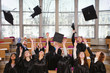 © Nejron Photo - Multi ethnic group of graduated students throwing hats