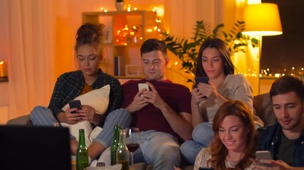 Wall Mural - friendship, people, technology and entertainment concept - happy friends with snacks and non-alcoholic drinks watching tv and taking selfie by smartphone at home in evening