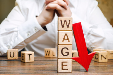 Wall Mural - Wooden blocks with the word Wage and red arrow down. Salary reduction. Drop in profits. Financial crisis. Demote. Low profit. Capital outflow. Concept of business and finance. Recession. Businessman