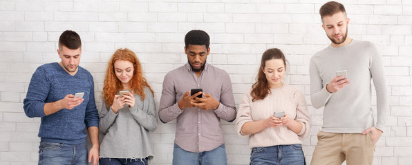 Gadget addiction. Group of students with smartphones