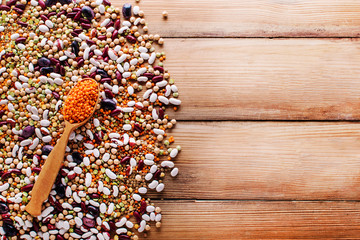 Wall Mural - Raw legume on old rustic wooden table, close-up. copy space top view