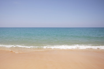 Wall Mural - Idyllic crystal beach and seawater in front of luxury hotel, attractive clear sea, nature coastline backgrounds during holidays sunbathing, wave from clear blue green sea and fine sand