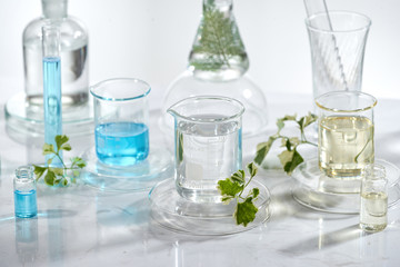 Wall Mural - laboratory glass equipment with natural ingredients on white background