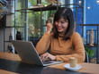 © chayathon2000 - Asian woman using laptop in coffee shop cafe