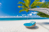 Tropical beach background as summer landscape with beach swing or hammock and white sand and calm sea for beach banner. Perfect beach scene vacation and summer holiday concept. Boost up color process