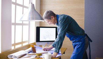 Engineer carpenter working on laptop and sketching project