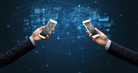 Close up of two hands holding smartphones to sync business data