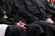 Representatives Of The Orthodox Clergy In Black Robes Sit In The Conference Hall. Meeting Clerics And Priests. Conceptual Background For Design And News About Religion.