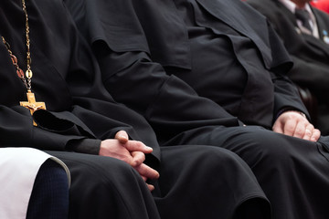 Representatives of the Orthodox clergy in black robes sit in the conference hall. Meeting clerics and priests. Conceptual background for design and news about religion.