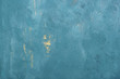 The texture of the blue wall. Aquamarine wall with drips of golden paint. Decorating the walls in a loft style. Spray paint on the wall. Venetian plaster background