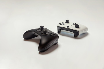 White and black two joystick gamepad, game console isolated on white background. Computer gaming technology play competition videogame control confrontation concept. Cyberspace symbol