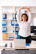 © Elnur - Middle-aged female employee doing exercises in the office