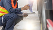 © KM.Photo - Preforming a pre-trip inspection on a truck,Concept preventive maintenance truck checklist,Truck driver holding clipboard with checking of truck.