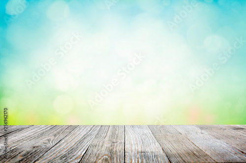 Background with sunny meadow over wooden deck