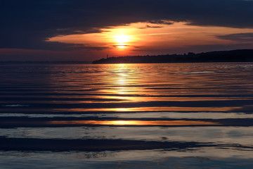 Wall Mural - river sunset sun clouds waves