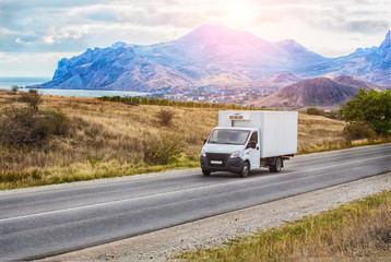  truck moves along the road along the sea