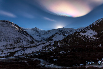 Wall Mural - Rainbow cloud over the Himalayas. Sunset in the mountains, Nepal, Tilicho Base Camp, Annapurna region.