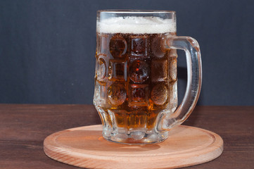 mug of beer on dark background