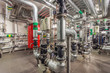 Central heating system in the basement of an large building. Pipelines, water pump, valves, manometers