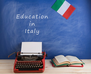 Fototapete - Education concept - red typewriter, flag of the Italy, books and blackboard with text 