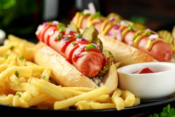 Wall Mural - frankfurter Sausage hotdogs with french potato fries, chips. crinkle cut gherkins, ketchup and mustard. take away. fast food