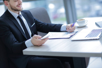 Wall Mural - closeup.businessman checking financial statement,sitting at the Desk