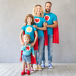 Family of superheroes playing at home