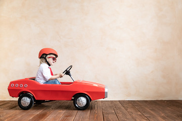 Canvas Print - Funny kid driving toy car at home