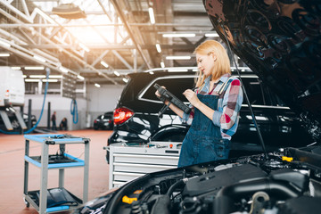 Wall Mural - attractive famale mechanic enjoying her work, close up photo. copy space