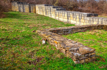 Solid stone wall and ruins of ancient fortress