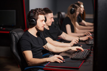 Casual gamers and hardcore fans are gather together in pc gaming club to compete in playing MMO Games online Tournament