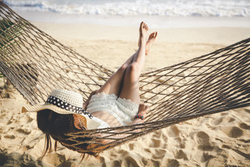 Wall Mural - Happy woman relaxing in hammock