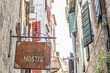 Wooden sign announcing a hostel on a narrow street, Montenegro, Europe