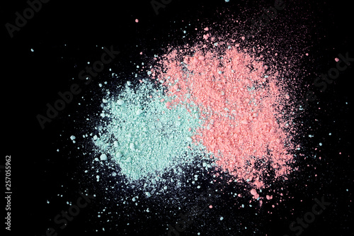Pile of natural colored pigment powder. Green pink  powder particles splatter...