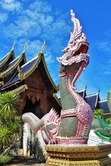 Wall Mural - beautiful of two Naga in front of the church at Banden temple, Chiang Mai, Thailand. Naga sculpture in front of the Thai temple and sky background. Thai modern culture.