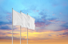 Three White Blank Flags Waving In The Wind Against Sunset Sky. Perfect Mockup To Add Any Logo, Symbol Or Sign