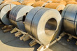 Round rolls of steel piled on pallets in stock