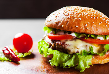 Wall Mural - burger with meat, cheese and vegetables on wooden board