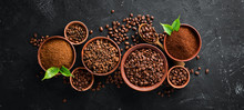 Ground Coffee And Coffee Beans. Assortment Of Coffee Varieties On A Black Background. Top View. Free Space For Your Text.