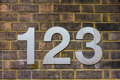 House Number 123 With The One Hundred And Twenty Three In Large Silver Numbers On A Yellow Brick Wall Stock Photo Adobe Stock House Number 123 With The One Hundred And Twenty Three In Large Silver Numbers On A Yellow Brick Wall Stock Photo Adobe Stock