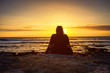 © bondvit - girl looks at the Sun Setting on Atlantic Ocean in Tenerife Canary Island Spain