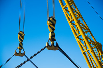 Wall Mural - Loading in port. Floating port crane on blue sky background