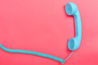 Retro phone on a pink paper background